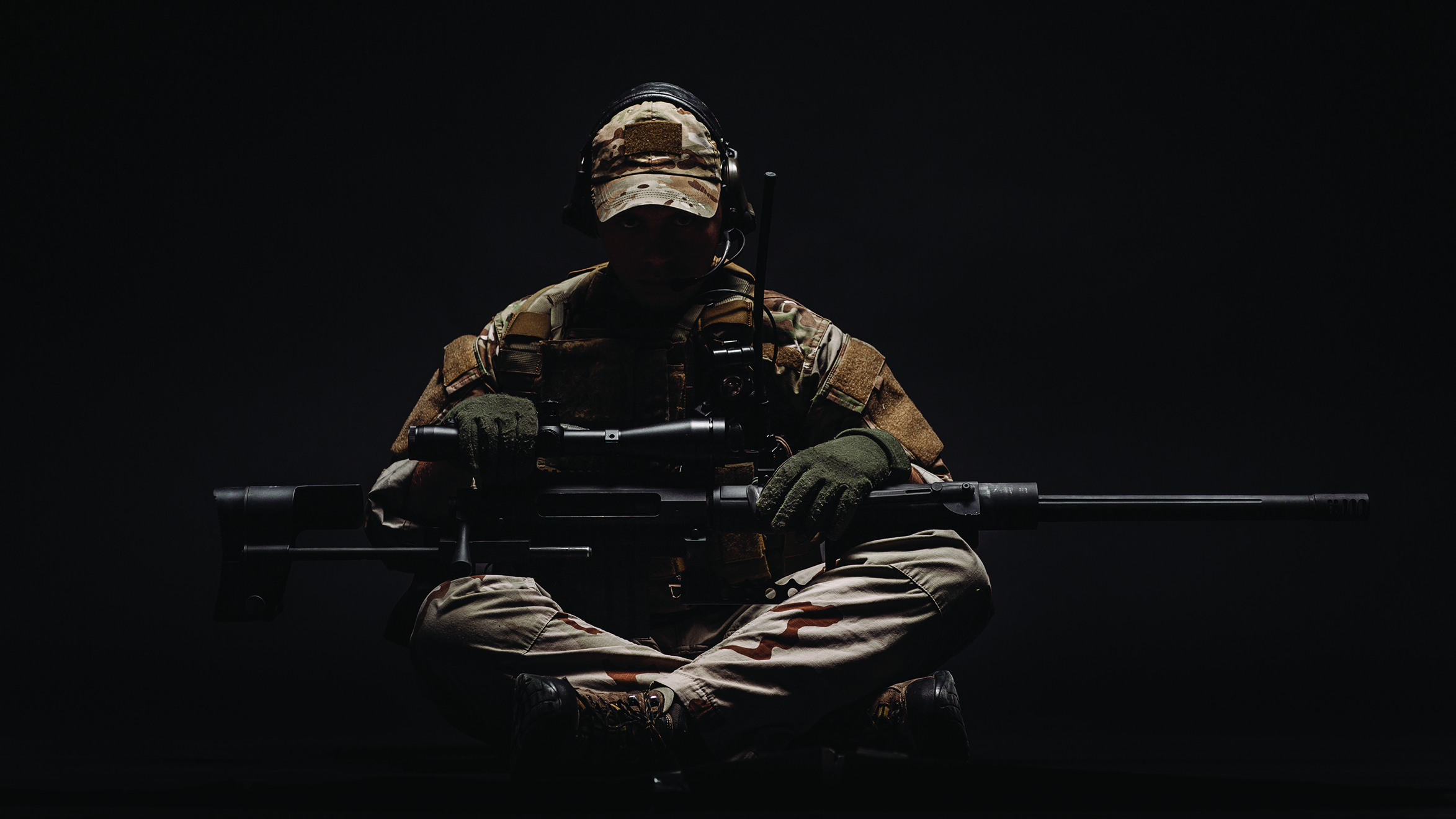 Soldier seated with gun